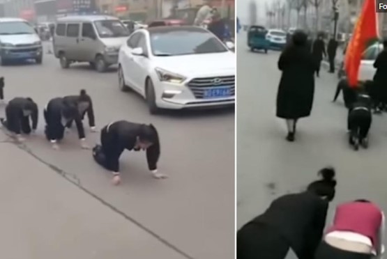 Viral video shows employees who missed targets forced to crawl along road as punishment