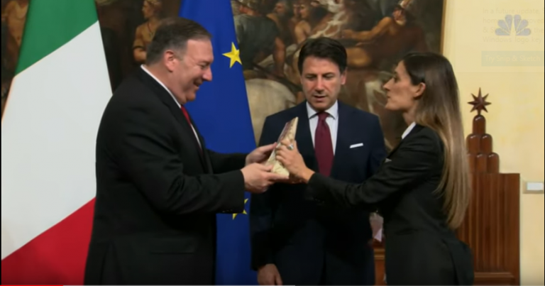 Woman crashes Mike Pompeo’s photo op with Italian PM Giuseppe Conte to give him a block of Parmigiano Reggiano cheese