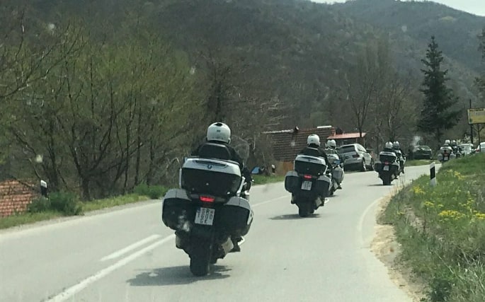 State security is guarding Zaev as he is riding a motorcycle after a week in isolation