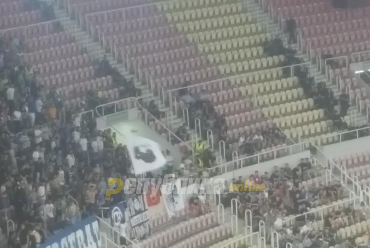 “Sverceri” fan group wave flag of UCK founder Adem Jashari during football match